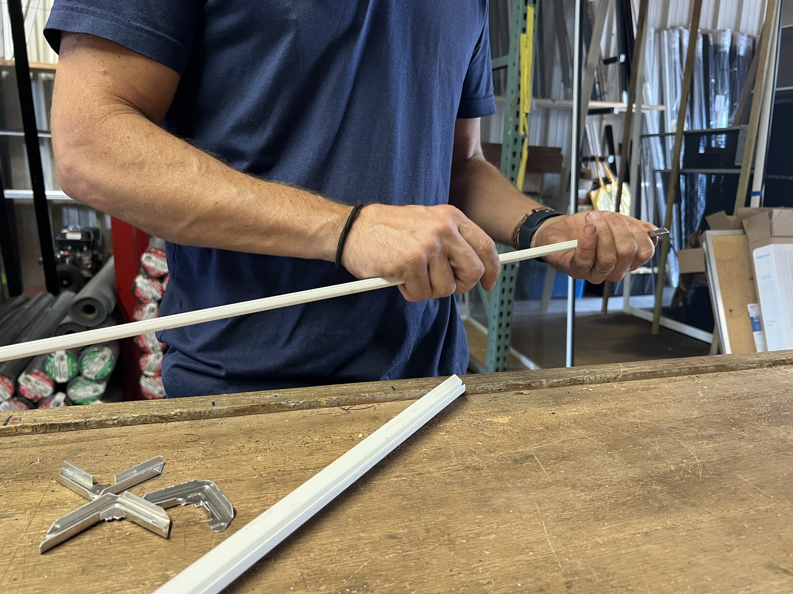 Fitting a corner clip and spline into a screen frame on the workbench